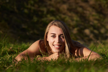 girl - blonde lying in the green grass