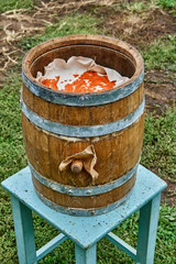 Oak Barrel. Open wooden barrel filled with milled hot pepper. Hot sauce production