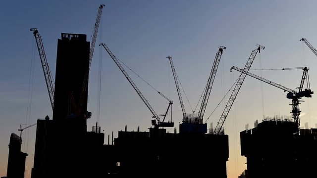 4K Time lapse of silhouette crane working in construction site