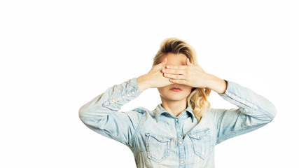 Beautiful young emotional girl closes her eyes to an isolated white background. Do not want to see