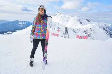 Crédence de cuisine en verre imprimé Sports dhiver Happy Young Woman Skier Enjoying Sunny Weather In Alps Stock Photo