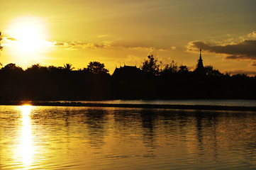 Fototapeta na wymiar Beautiful sunset over the lake in Thailand in orange color background