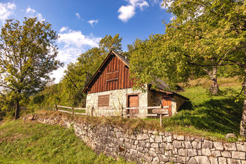 View of a rustic stone and wooden chalet in the mountains