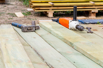 Drill, hammer and wrench on a construction site. Building tools.