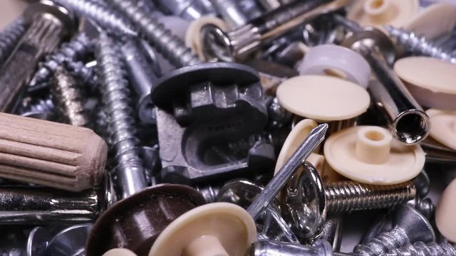 macro screws, nuts, rivets, caps rotate, construction and repair concept.