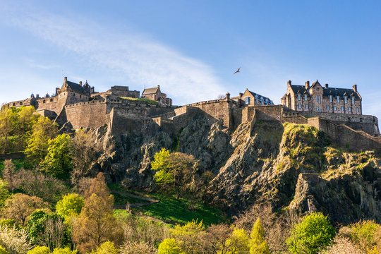 Edinburgh Castle, historic fortress built on the top of a volcanic rock, on a beautiful blue sky Spring day, famous tourist attraction in Scotland, UK.