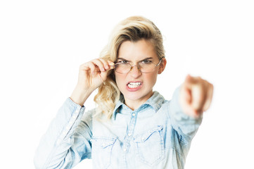 Young beautiful girl teacher in glasses emotionally reeks and shouts with a finger. Concept is evil doctor