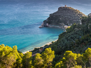 Beautiful aerial view of Baia dei Saraceni with blue Mediterranean sea and a stone watchtower near Varigotti, quaint fisherman village near Finale Ligure, Savona, Liguria, Italy, Italian Riviera