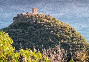 Beautiful sunset aerial view of a stone watchtower on top of a hill in Varigotti, quaint fisherman village near Finale Ligure, Savona, Liguria, Italy, Italian Riviera