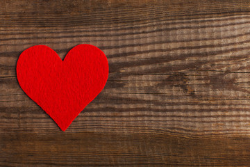 Red hearts on a wooden table. Blank or greeting card background for Valentine's Day. Place for text, copy space.