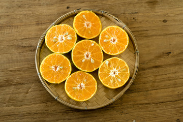 Fototapeta na wymiar slices of orange on wooden table