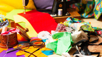 Sewing on a sewing machine design. Making objects with your own hands. Multicolored threads and fabrics. Hobby. Retro.