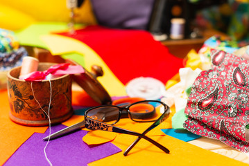 Sewing on a sewing machine design. Making objects with your own hands. Multicolored threads and fabrics. Hobby. Retro.