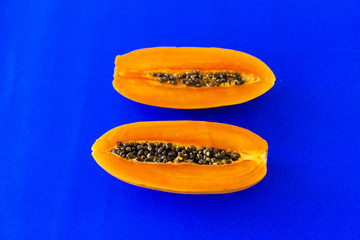 cutting papaya on colorful background
