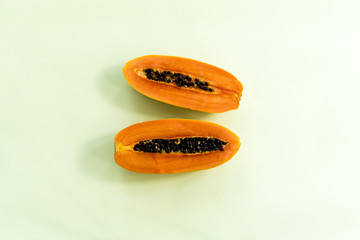 cutting papaya on colorful background