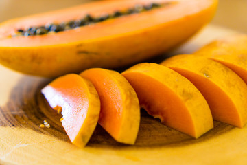 cutting papaya on wooden table