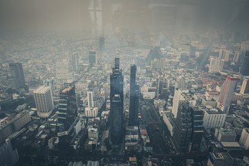 Obraz premium Cityscape of Bangkok the capital cities of Thailand covered by mixture of dust in air pollution, it is unhealthy. Taking photo pass glass.
