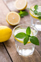 Fototapeta premium Glass of fresh cool lemon infused water detox drink. 
