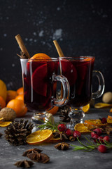 milled Hot wine with Christmas decorations background. Holiday dark photo.