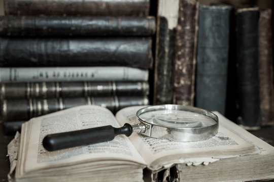 Books shelf with old open book