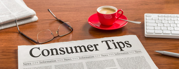 A newspaper on a wooden desk - Consumer Tips