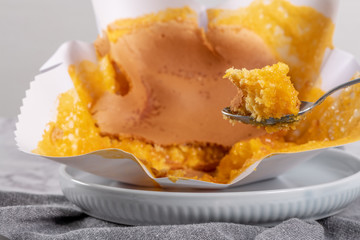 Portuguese sponge cake wrapped in the typical paper used on the baking, on marble background.