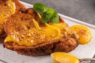 Traditional Christmas Rabanadas with cream of eggs and cinnamon. Spanish Torrijas close up on the countertop