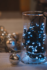 lights and silver christmas balls on white background