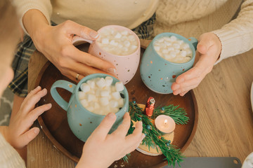 family drinking hot cacoa with marshmellow