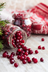 cranberries in a glass jar on a wooden table