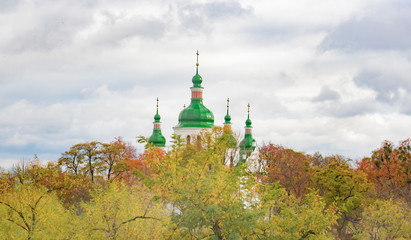 St. Cyril's Church in autumn leaves. Beautiful background with multicoloured trees