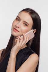 Portrait of a smiling woman talking by phone