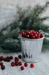 cranberries in a glass jar on a wooden table