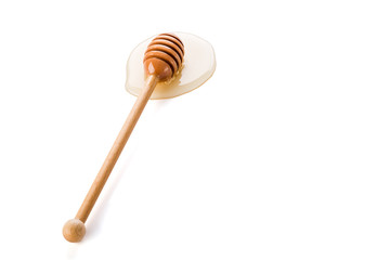 Honey and honey dipper on white background