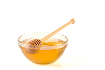 Fresh honey in glass bowl on white