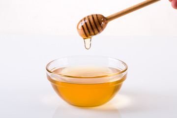 Honey with dipper and flowing honey