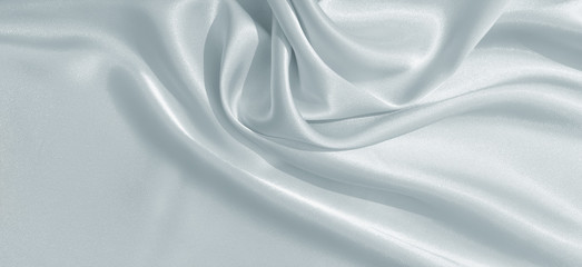 The texture of the satin fabric of blue color for the background