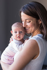 happy mother with her baby girl at home. Lifestyle indoors and family love concept