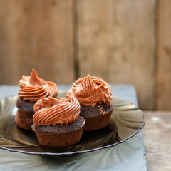 Super Moist Chocolate Cupcakes on wooden background. Selective focus, close-up.