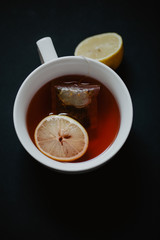 Close up of a tea cup with lemons