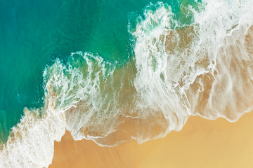 Aerial view of abstract turquoise ocean waves in Kelinking beach, Nusa penida Island in Bali, Indonesia.