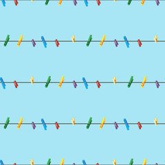 Seamless pattern Colored clothes pins on a clothes line rope on blue background . - 240607501
