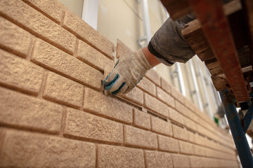 Installation of plastic siding under the brick