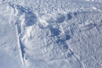 White snow on the mountainside as a background