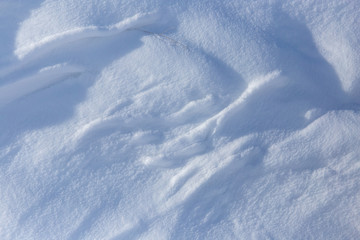White snow on the mountainside as a background