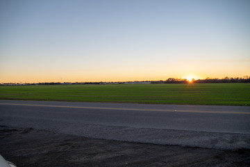 Evening sun setting behind sugar cane fields in New Roads, Louisiana. 