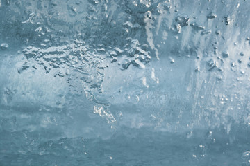 Naklejka na ściany i meble The texture of the ice. The frozen water.Winter background 