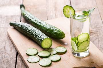 Cucumber summer cool water. Fresh cucumber slices and a glass of cucumber water
