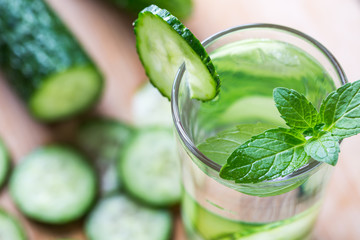 Cucumber summer cool water. Fresh cucumber slices and a glass of cucumber water

