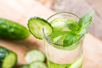 Cucumber summer cool water. Fresh cucumber slices and a glass of cucumber water
